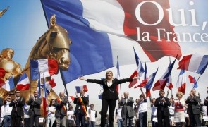 France's far right National Front political party leader Marine Le Pen waves on stage during her speech in front of the Opera following the National Front's annual May Day rally in Paris
