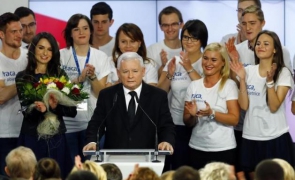 The leader of Poland's main opposition party Law and Justice Kaczynski addresses as his daughter Marta looks on after the exit poll results are announced in Warsaw